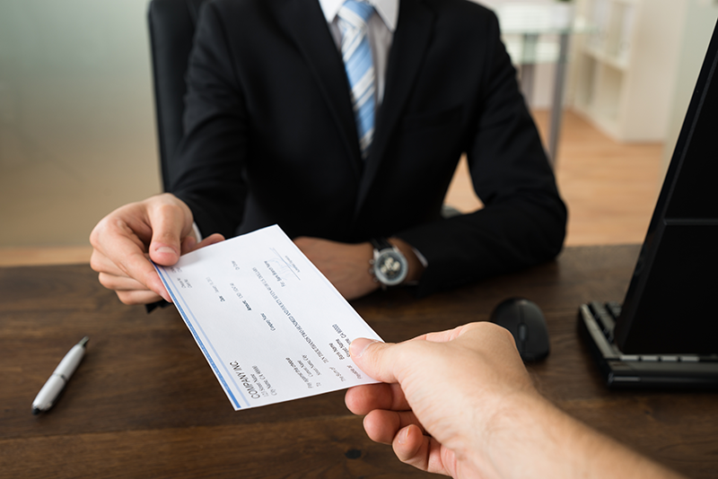Woman handing check