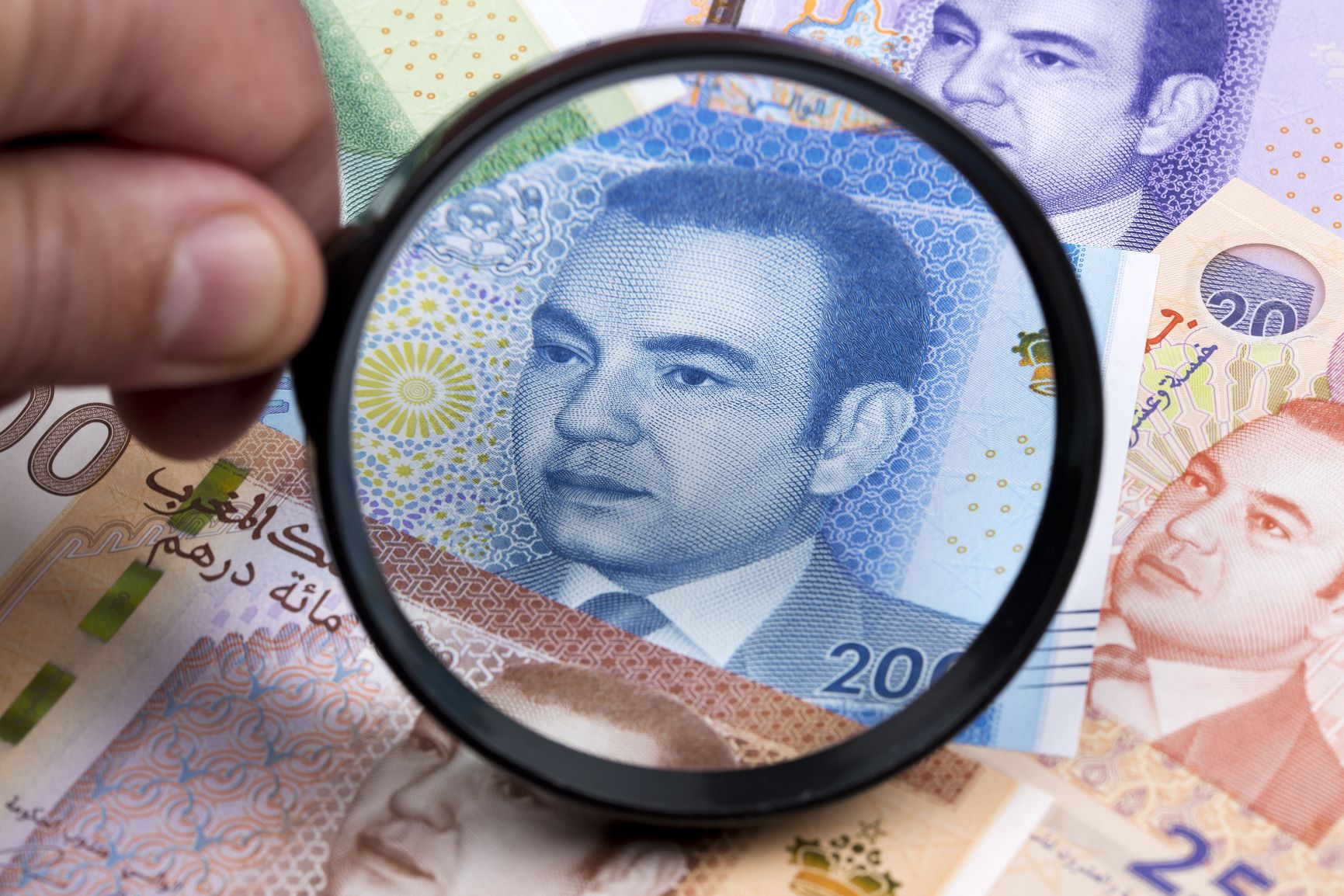 Moroccan dirham in a magnifying glass a business background