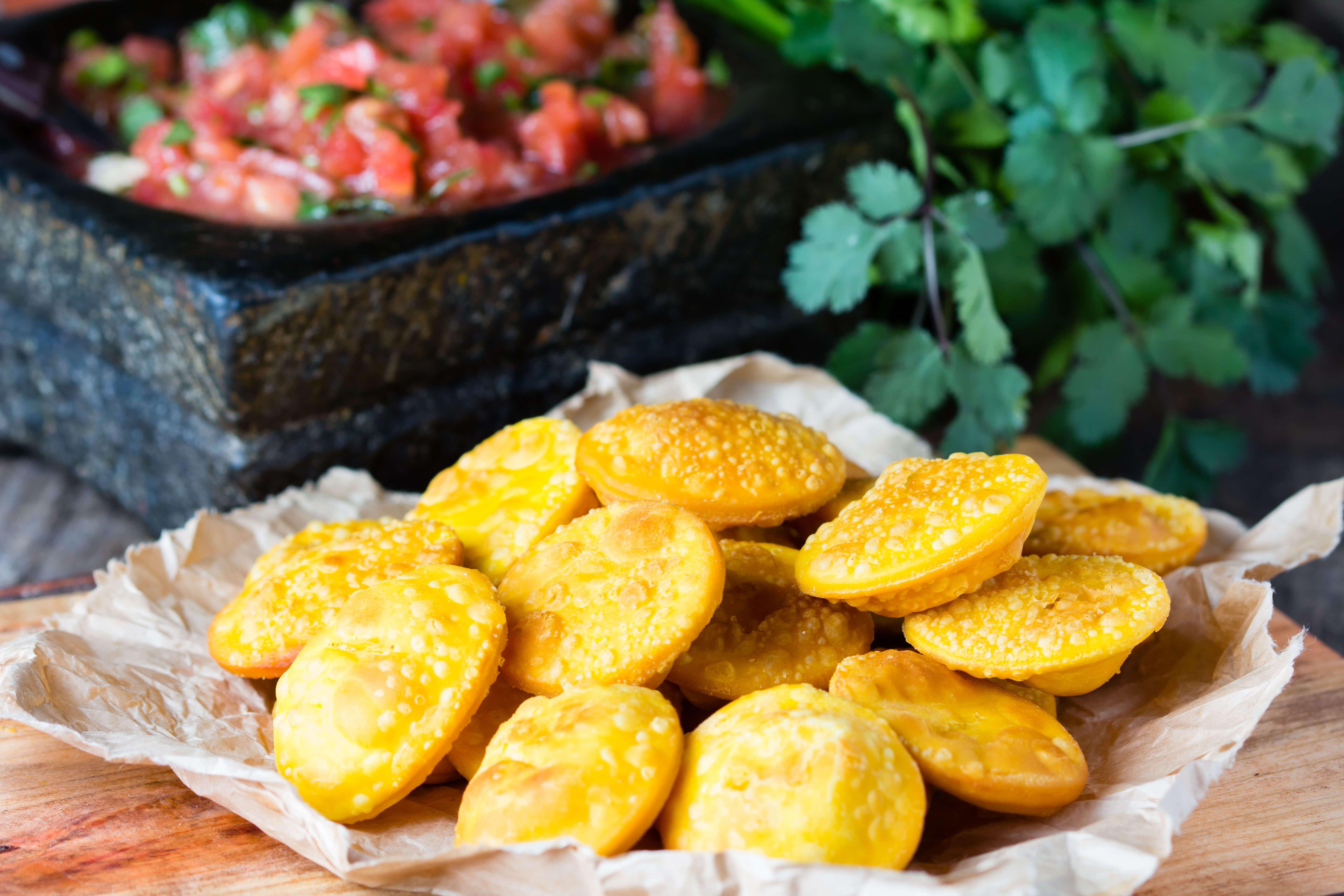 Traditional Chilean homemade pumpkin sopaipillas with salsa