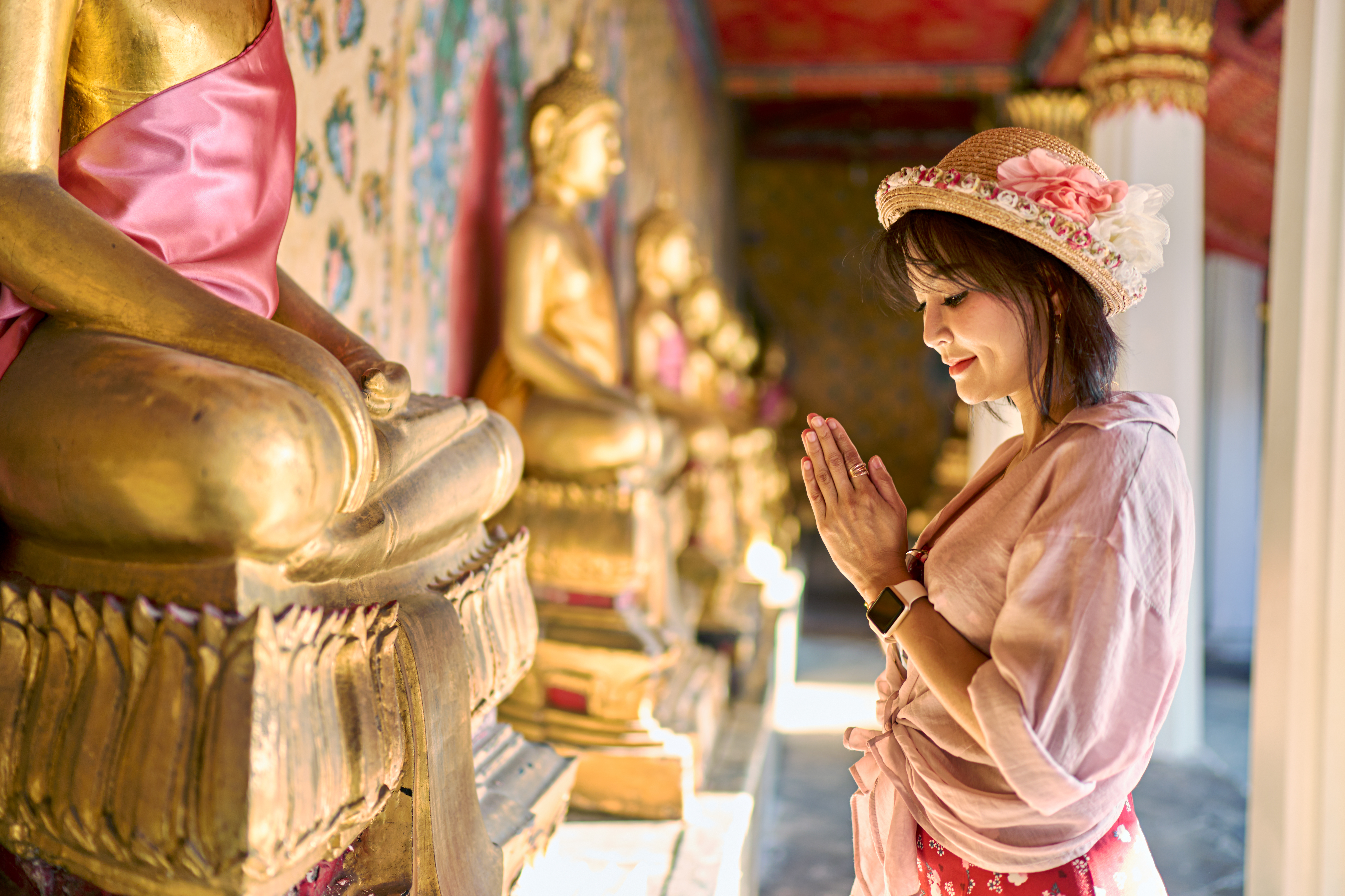 Thai Woman Praying in front Temple