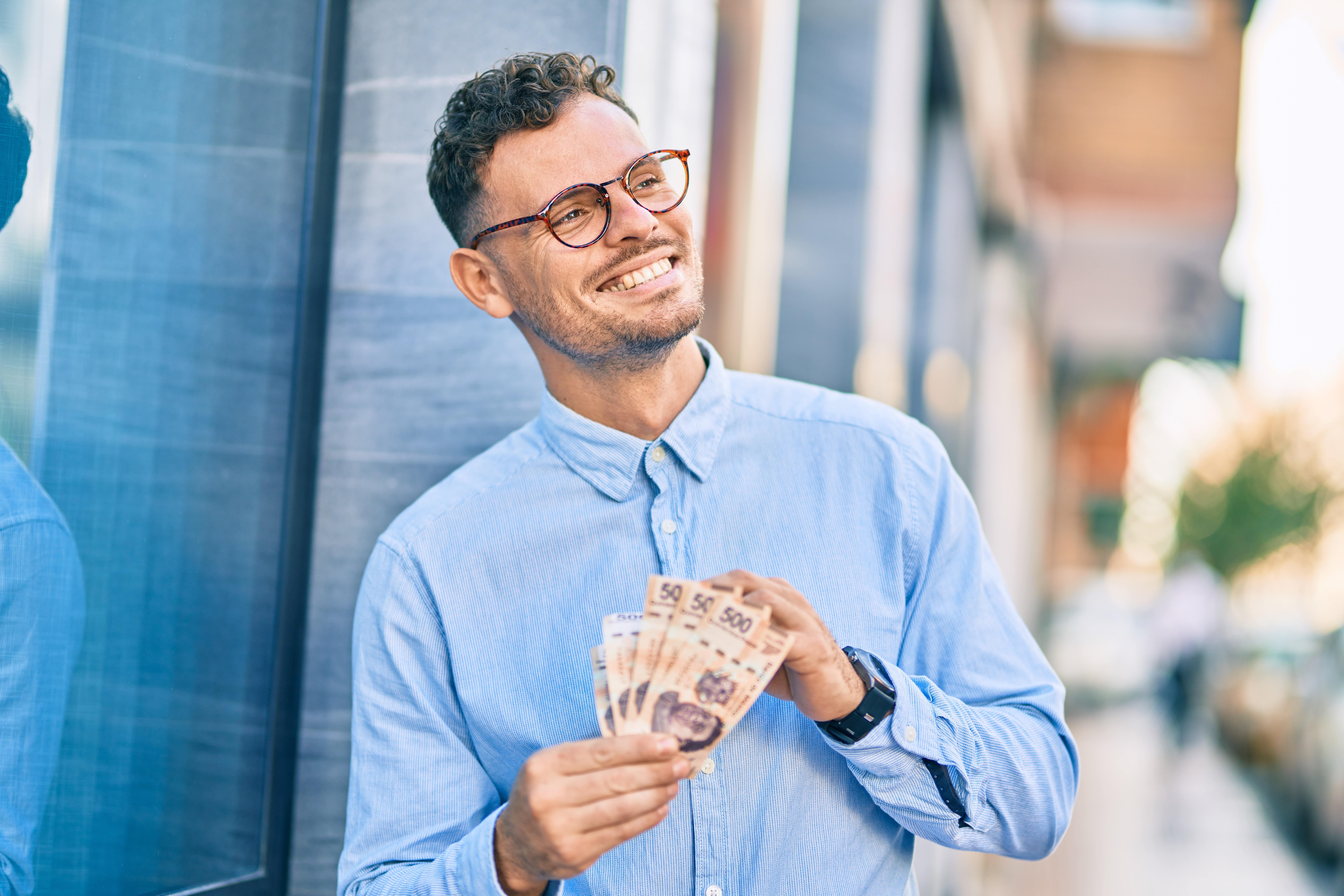 man holding mexican pesos