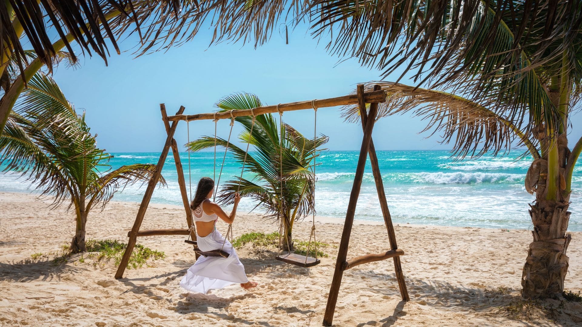 Woman swinging on the beach